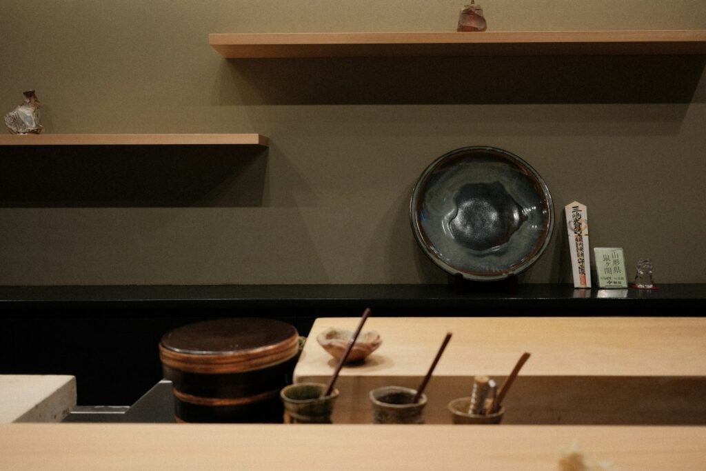 Sushi counter with small bowls and wooden shelves