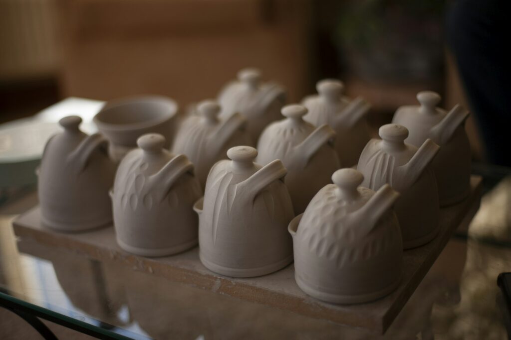 Several small ceramic pots arranged on a shelf