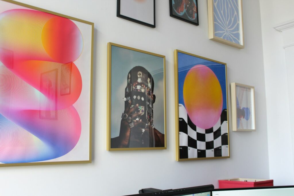 A wall with a bunch of paintings on it