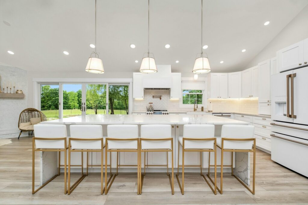 A large kitchen with a center island and white cabinets