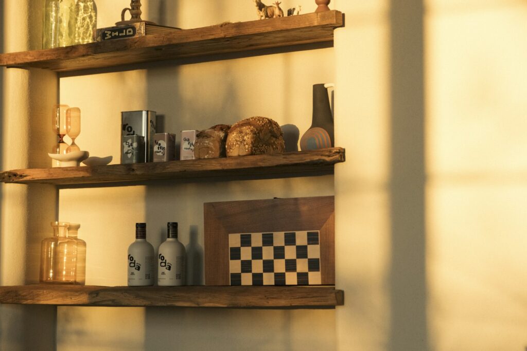 Wooden shelves display various decorative items and bottles