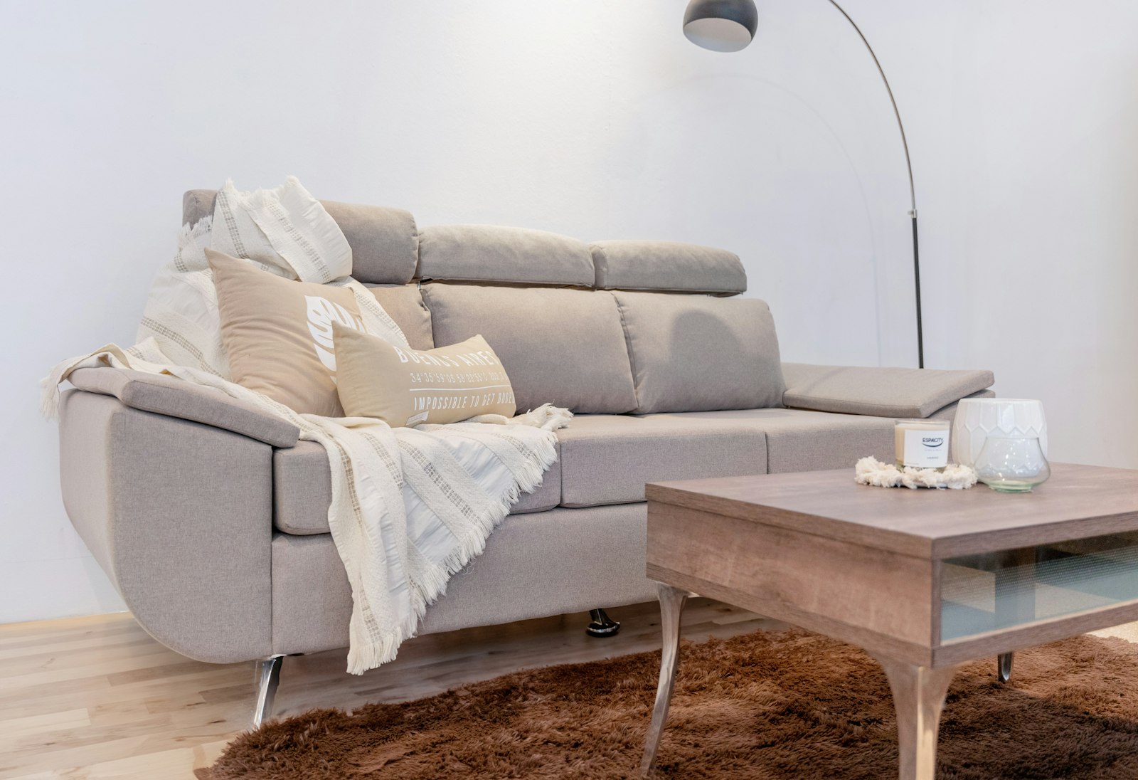 A comfortable sofa with throw pillows and blanket