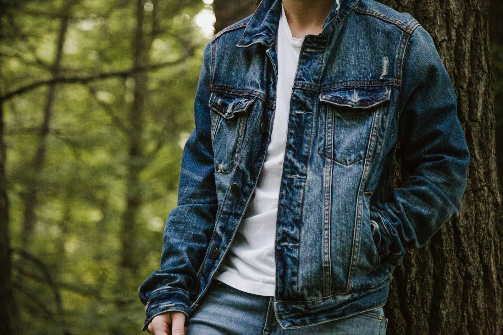Man leaning on tree