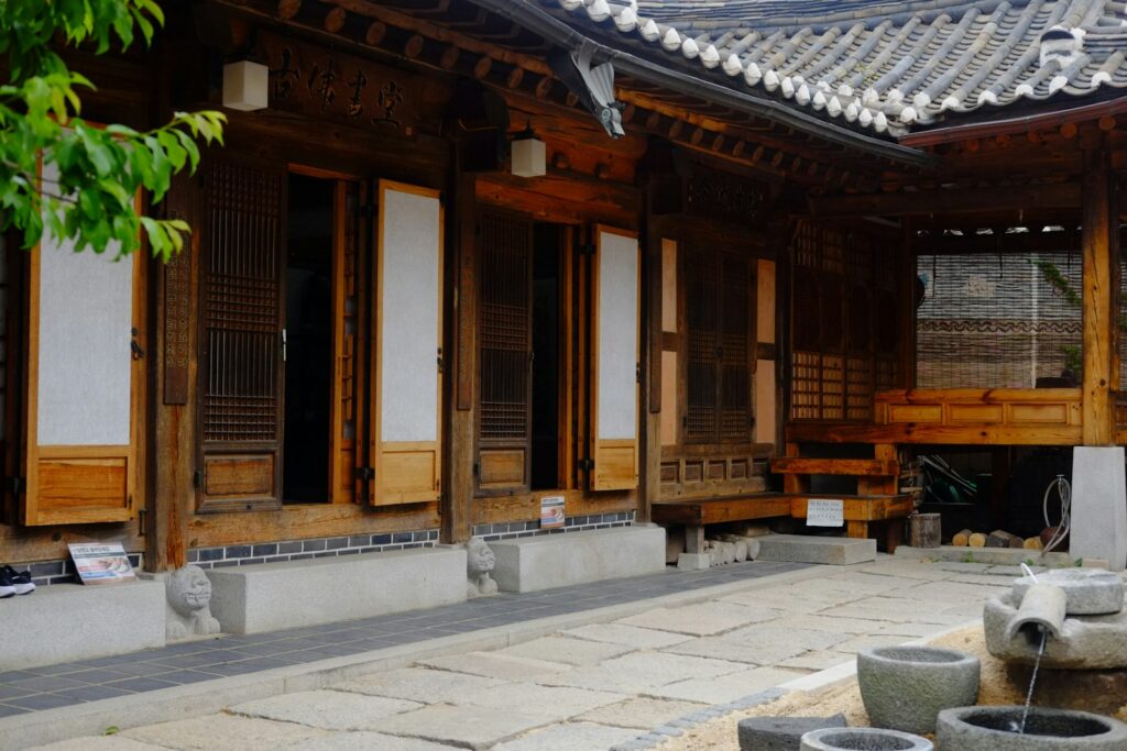 A traditional korean wooden house with a stone courtyard