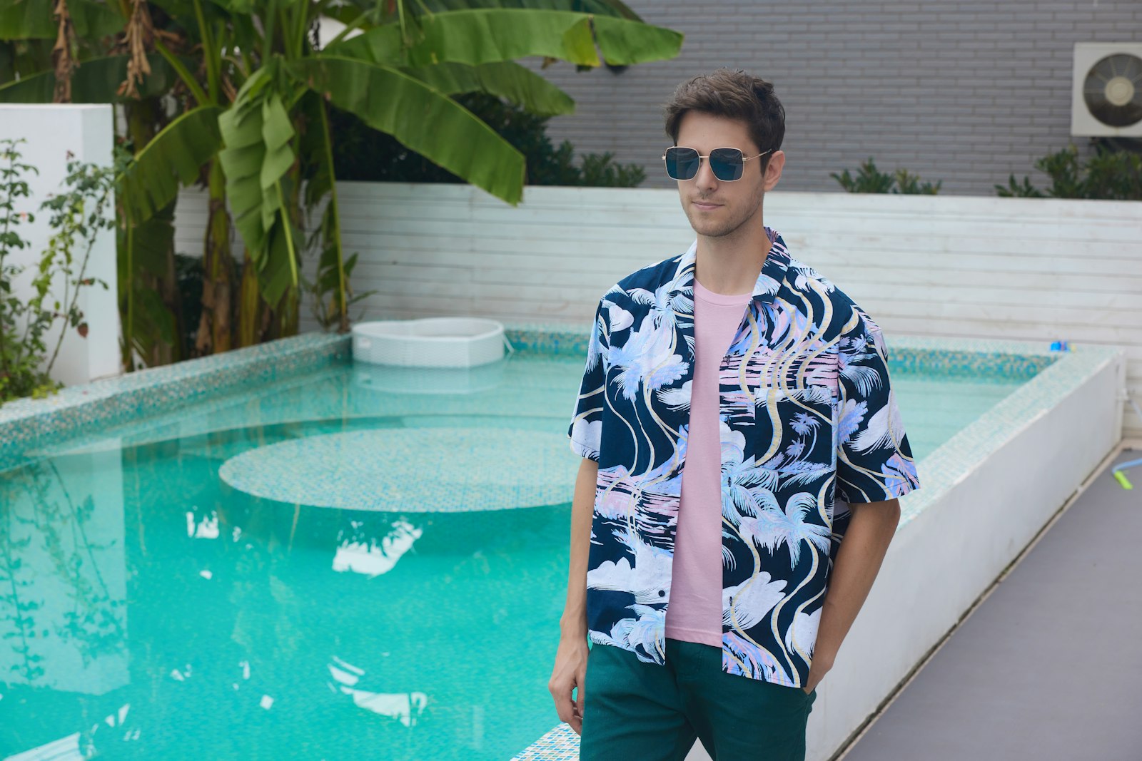 A man standing in front of a swimming pool