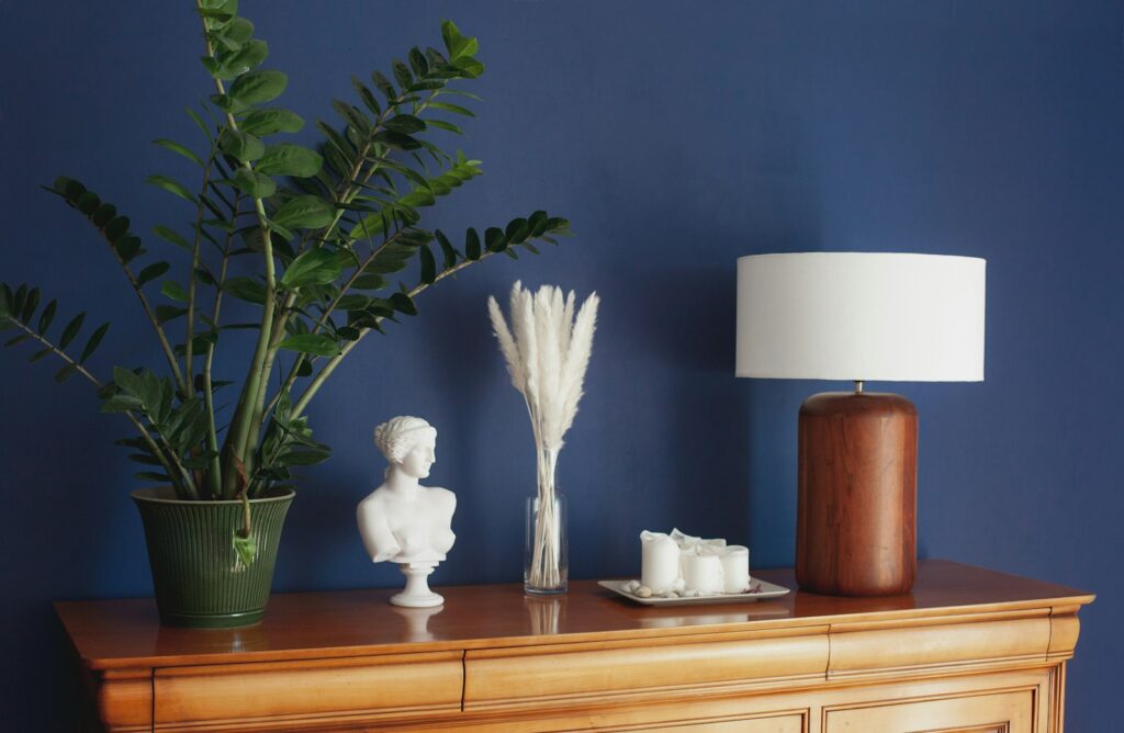 White flower in brown ceramic vase on brown wooden table