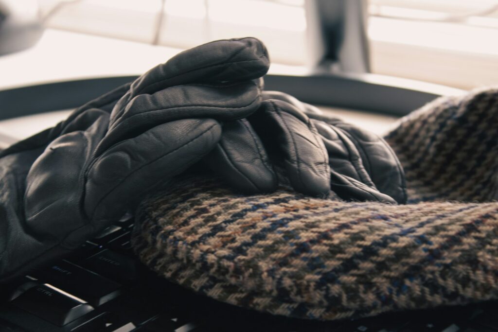 A pair of gloves sitting on top of a keyboard