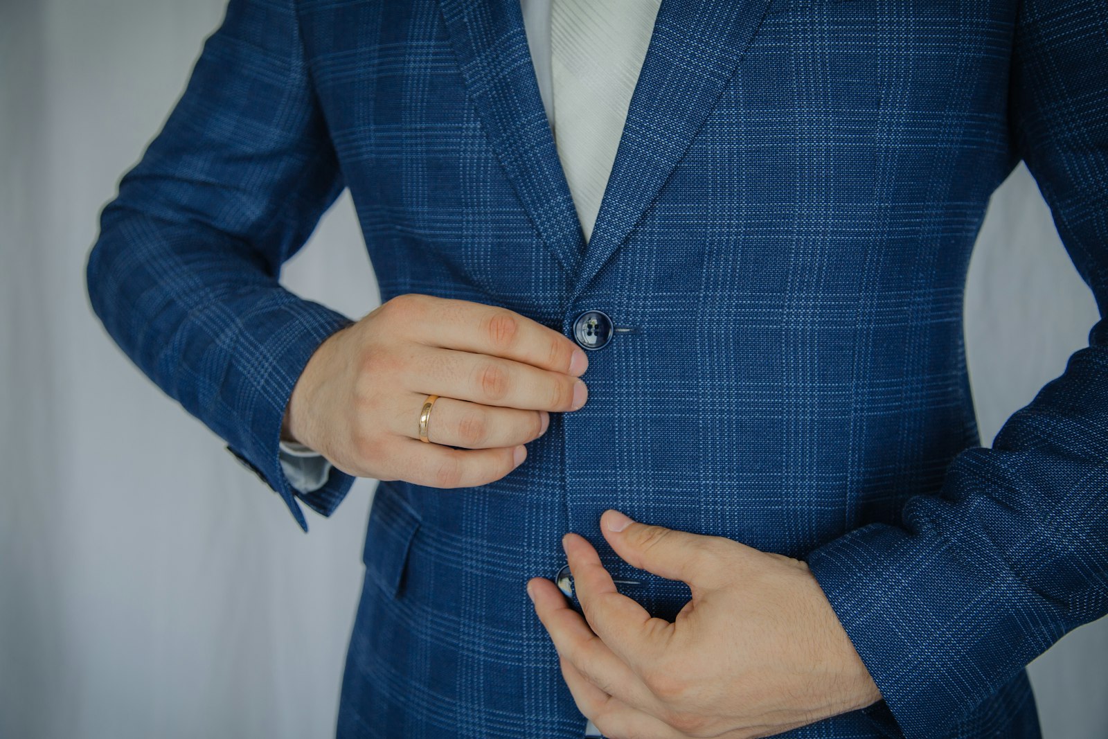 Man in blue and white plaid button up long sleeve shirt
