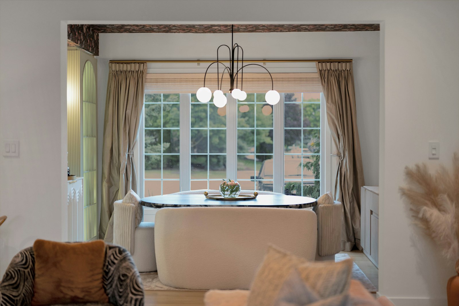 Elegant dining nook with a round table and large window