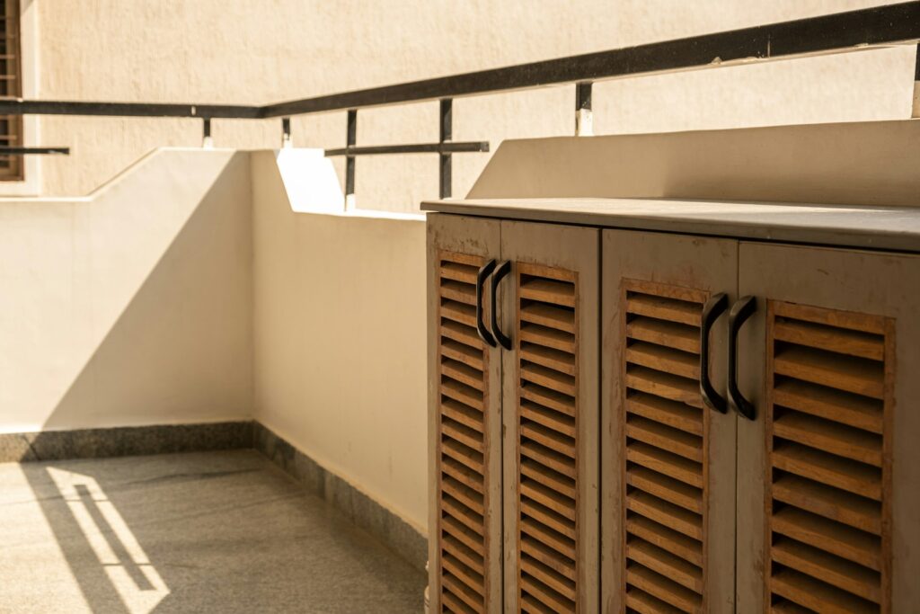 A row of wooden lockers sitting on top of a cement floor