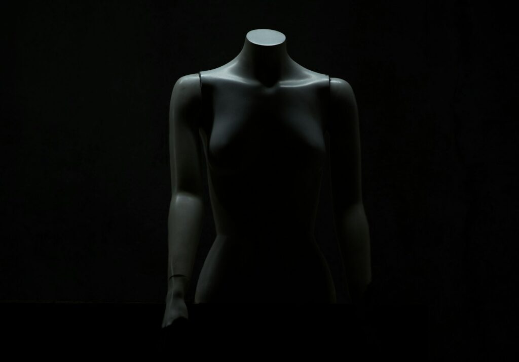 A mannequin's torso in a dark room