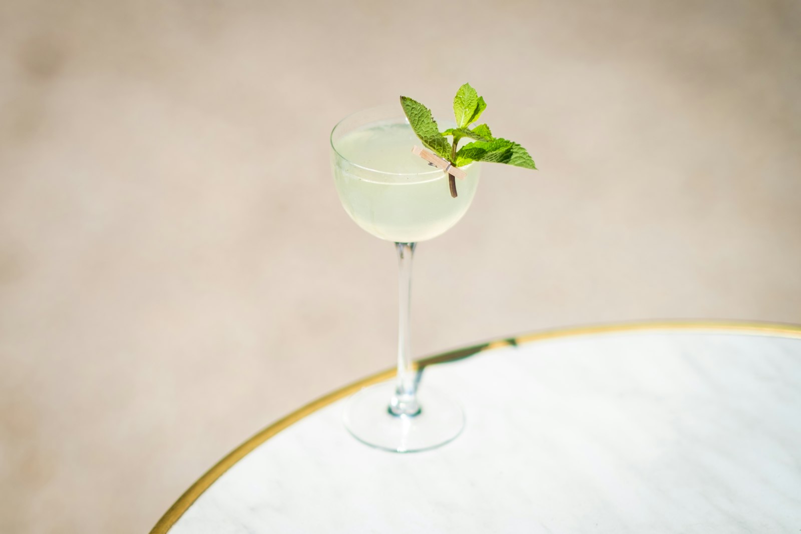 A glass filled with a drink sitting on top of a table