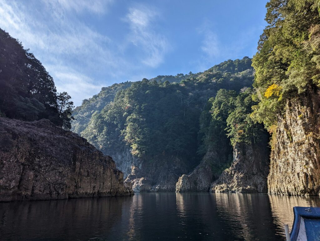 A boat is in the water near a mountain