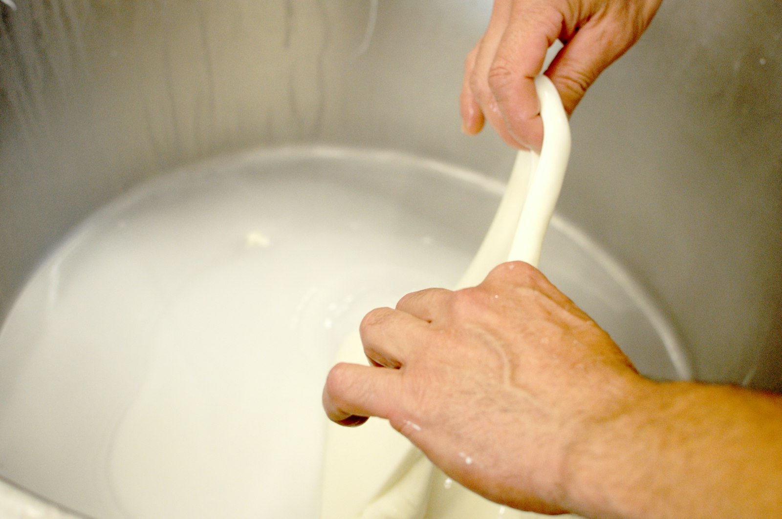 A person washing their hands in a sink