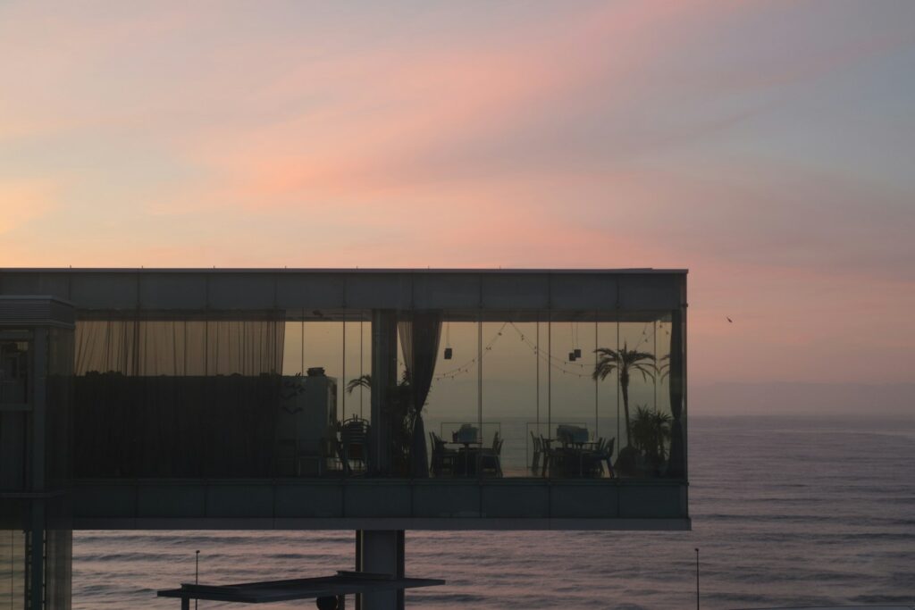 Modern building overlooking the ocean at a beautiful sunset