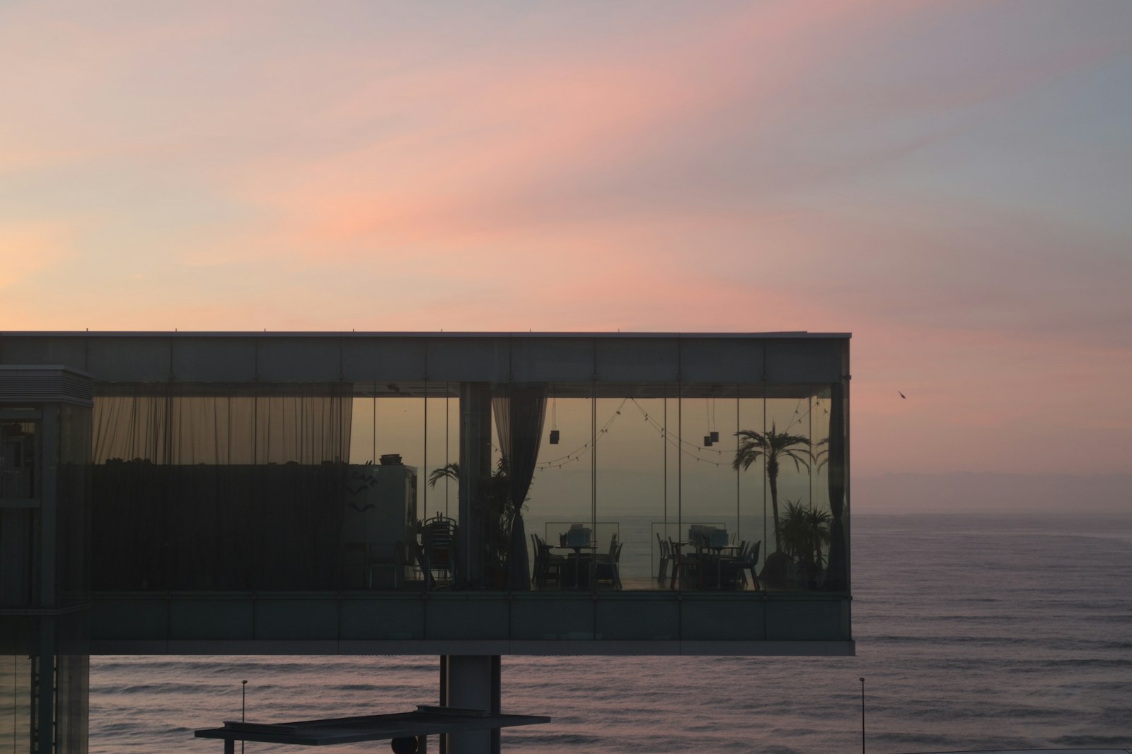 Modern building overlooking the ocean at a beautiful sunset