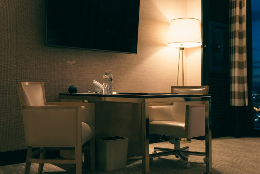 Desk with chairs and lamp in a dimly lit room