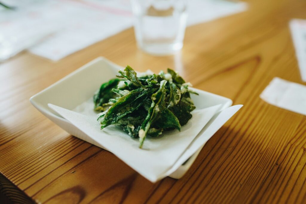 Green vegetable on white ceramic plate