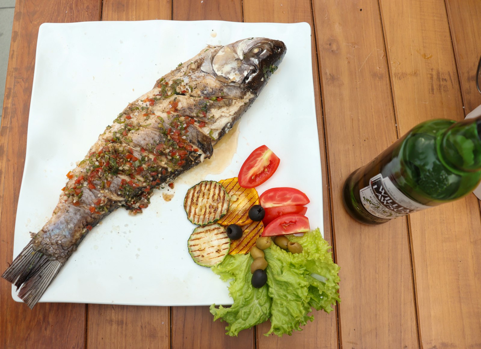 Grilled fish on white chopping board