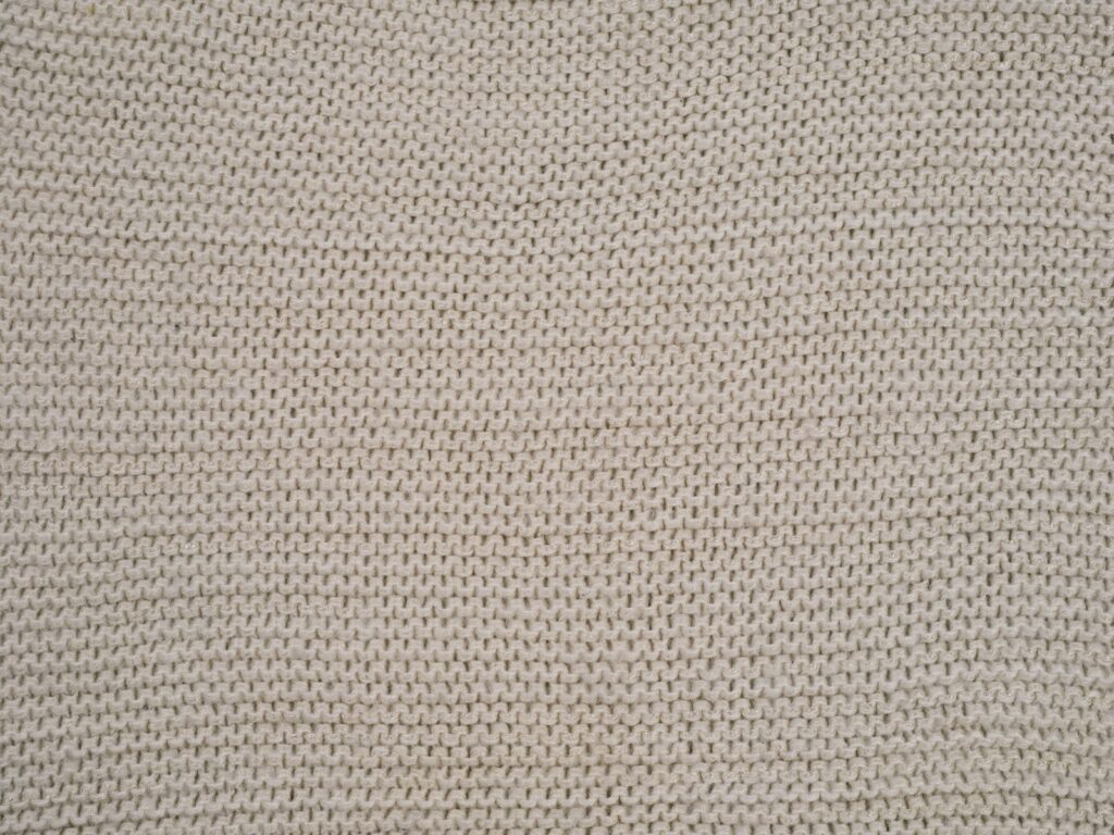 A close up of a white knitted material