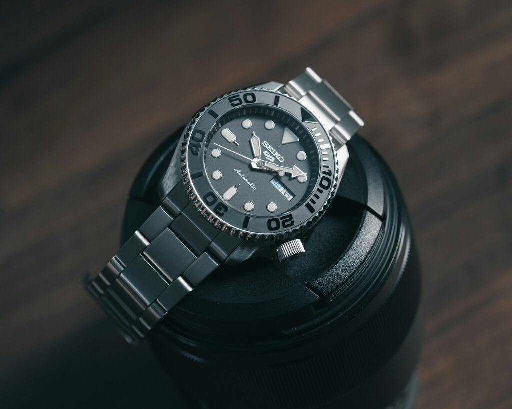 A watch sitting on top of a metal container