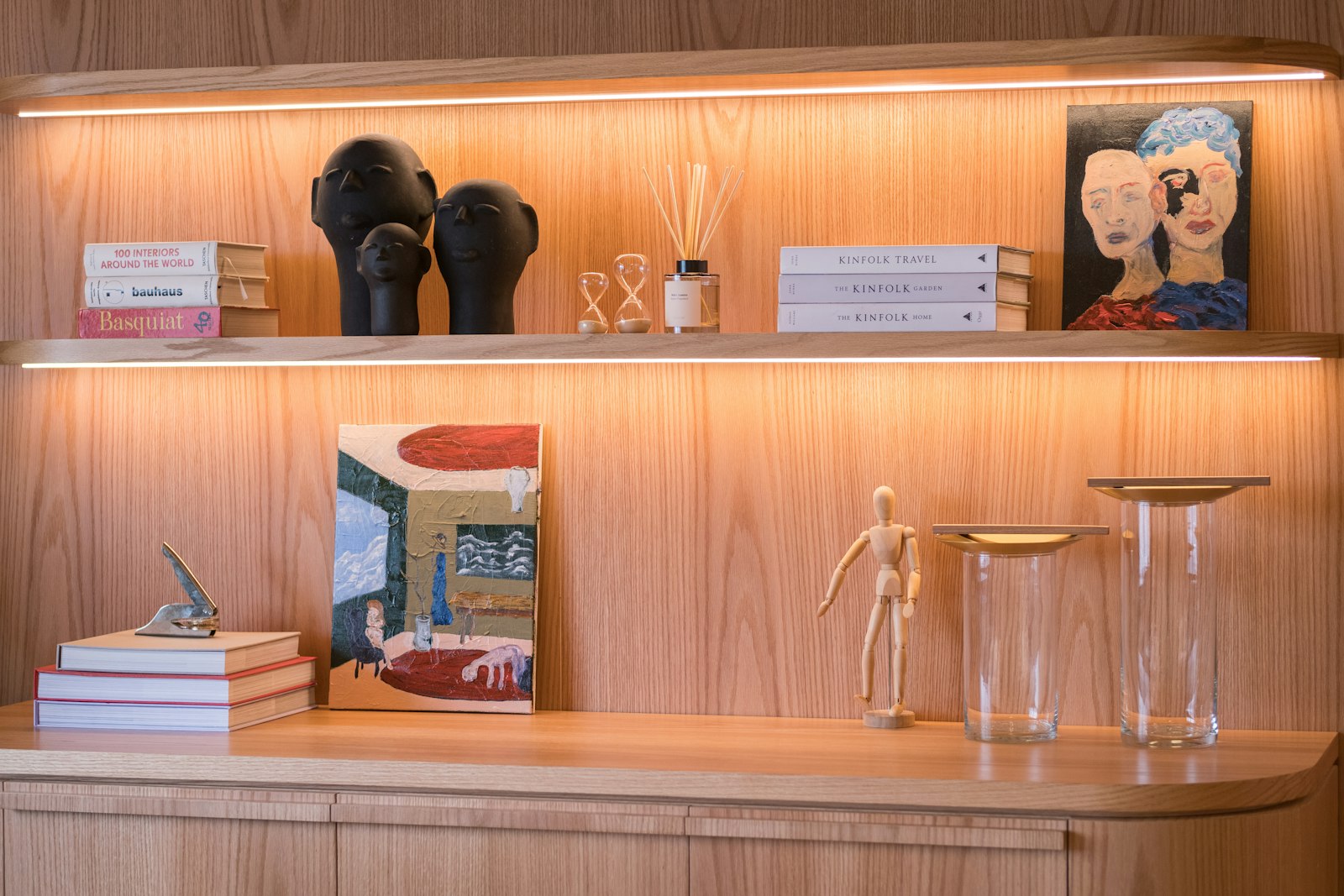 Decorated shelves with books, art, and sculptures