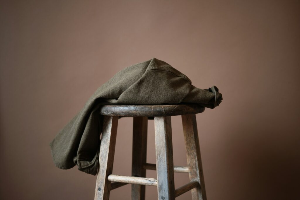 Gray textile on brown wooden seat