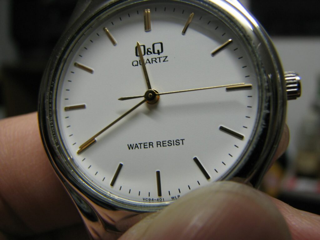 A hand holding a watch