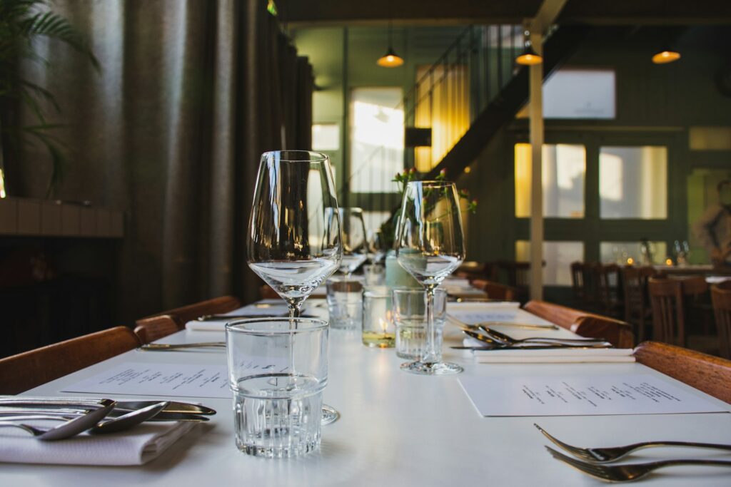 Clear wine glasses on top of dining table