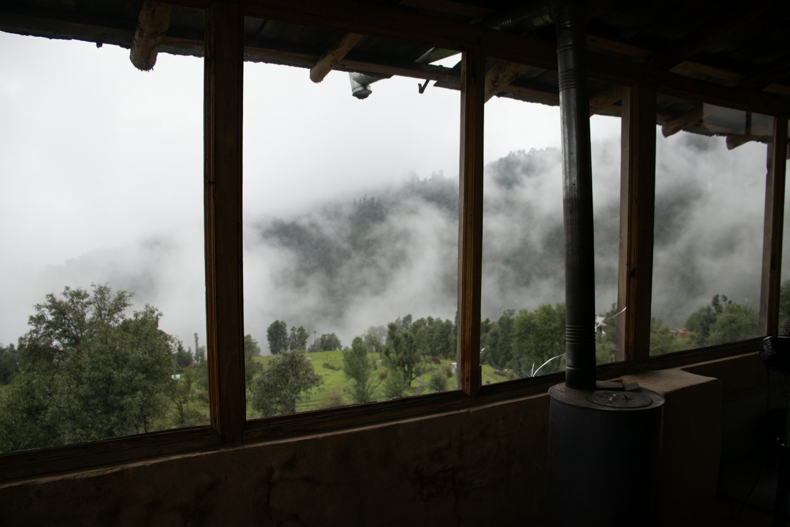 A misty mountain view through a window