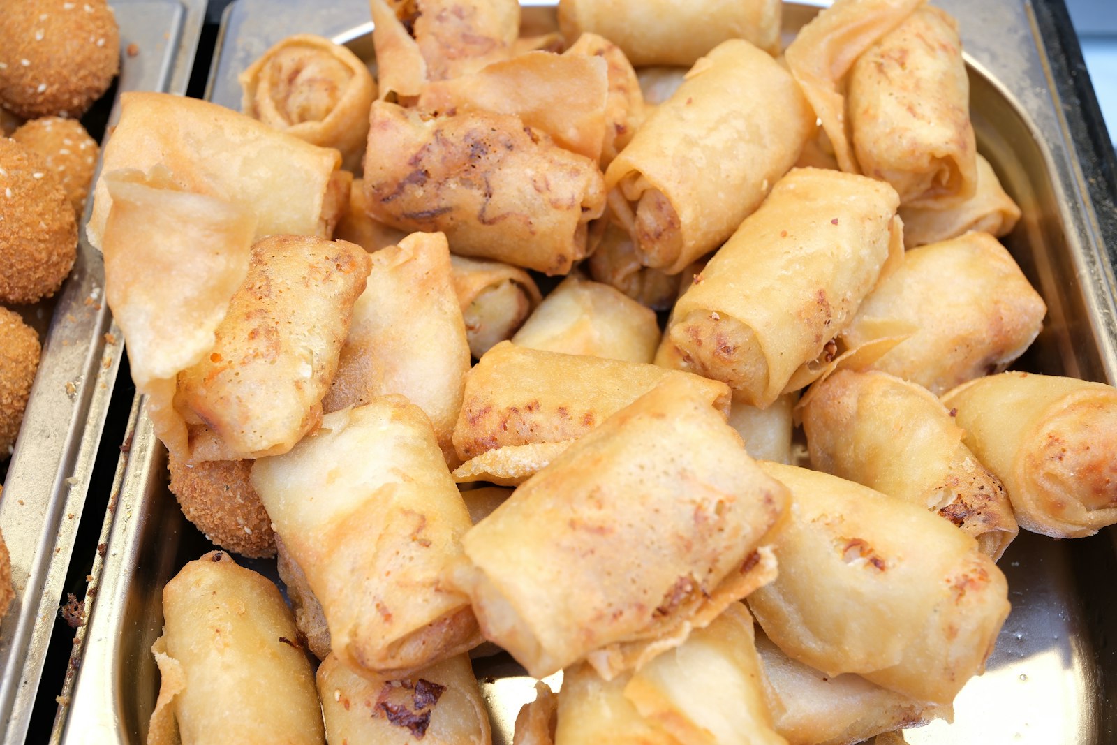 Fried spring rolls piled in a tray