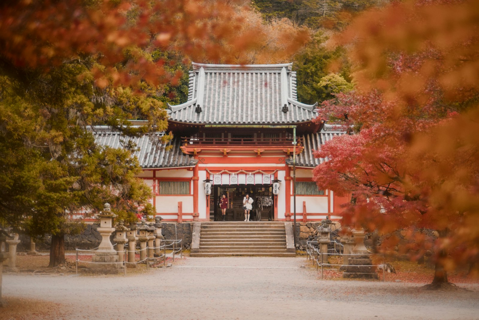 Japanese temple surrounded by vibrant autumn foliage