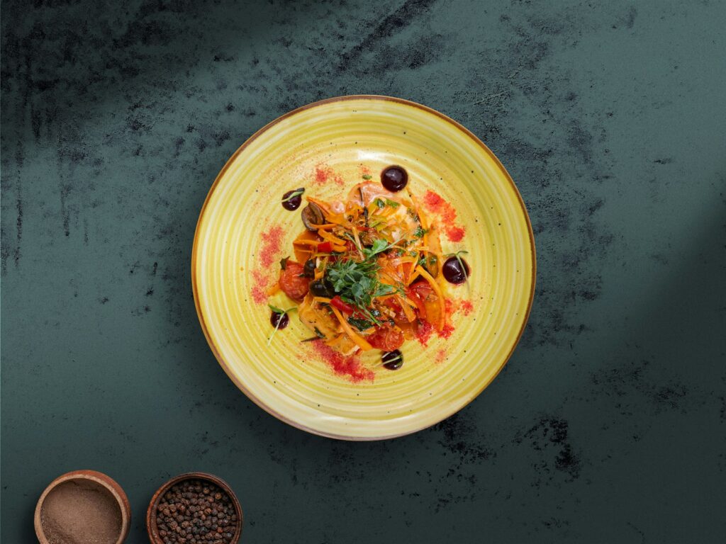 A colorful pasta dish with vegetables and olives