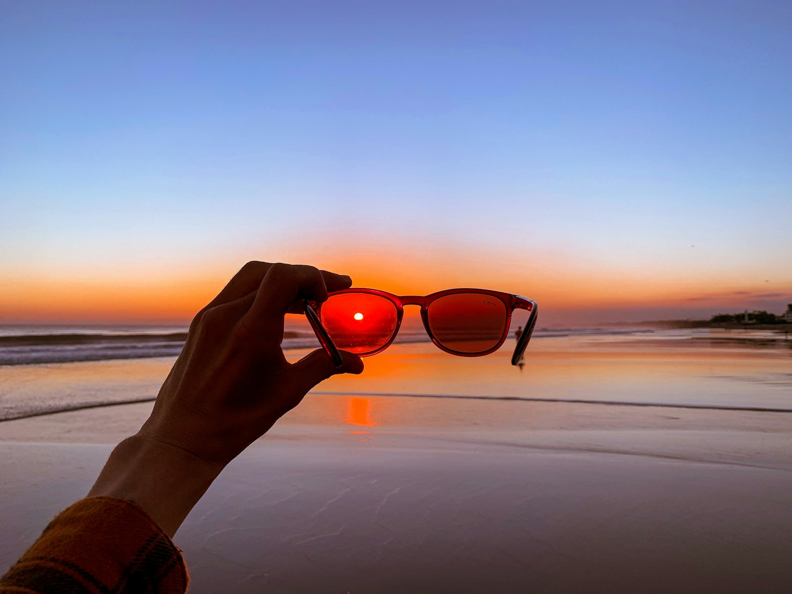 Person holding sunglasses