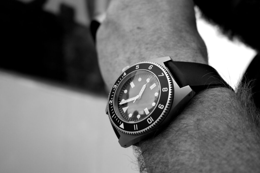 Grayscale photography of analog watch