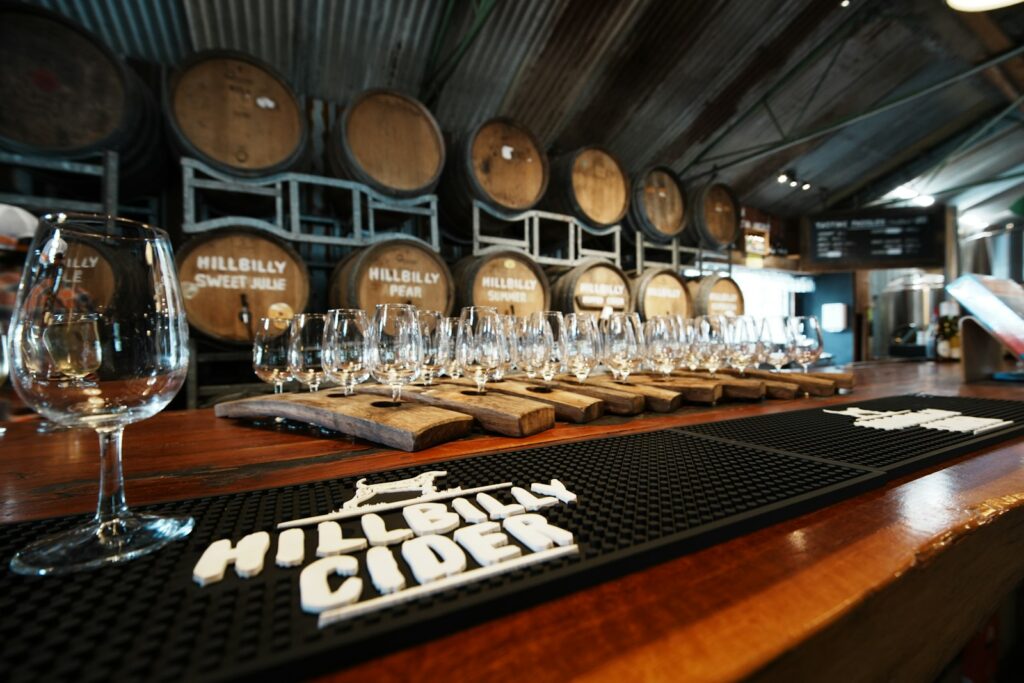 Bar with cider barrels and tasting glasses