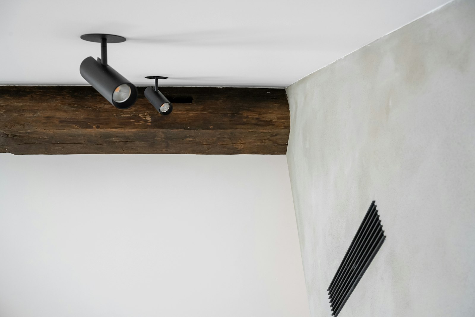 A bathroom with a toilet and a ceiling fan