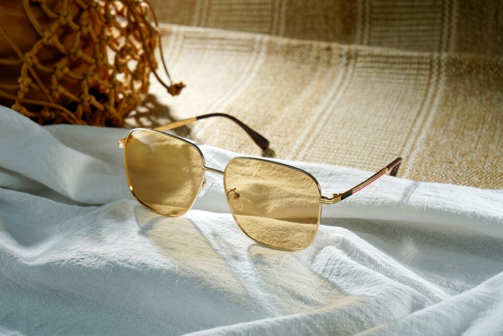 Stylish sunglasses resting on white fabric