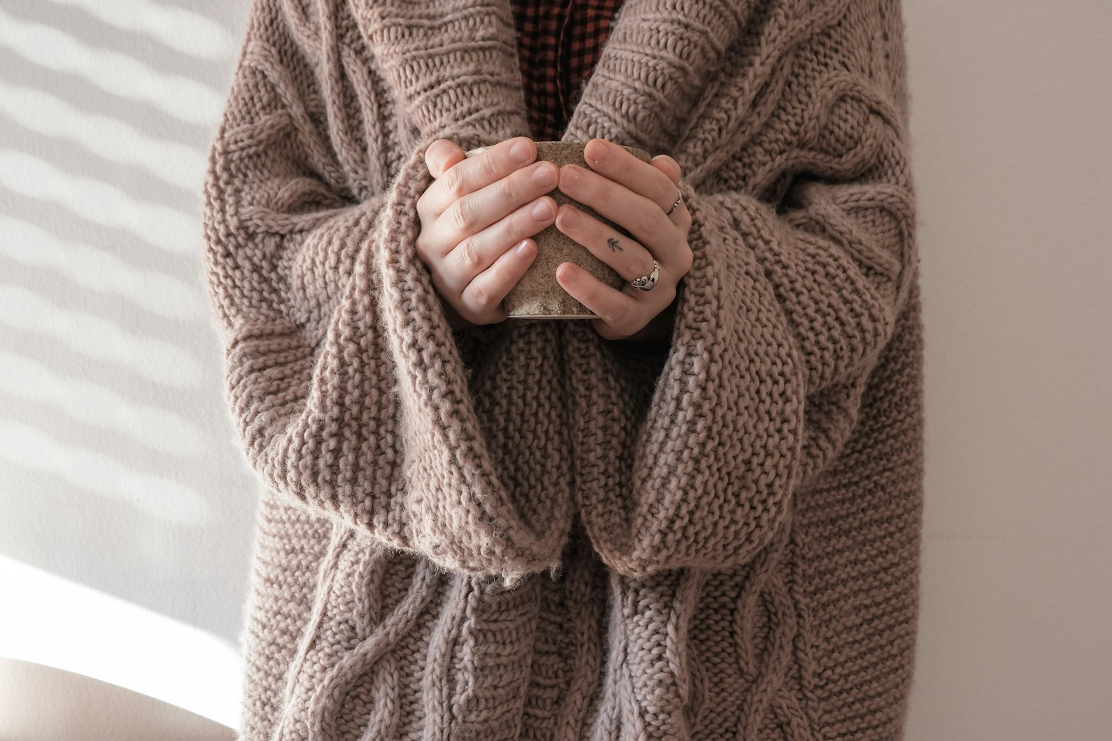 Person in brown knit sweater