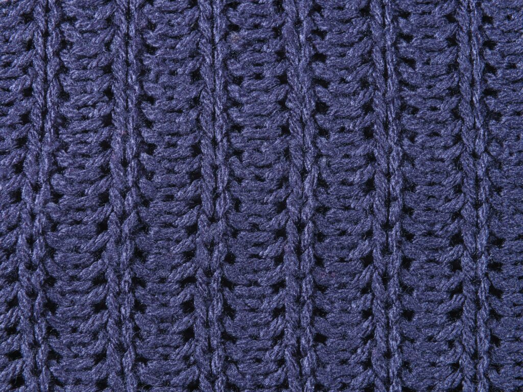 A close up of a blue knitted blanket