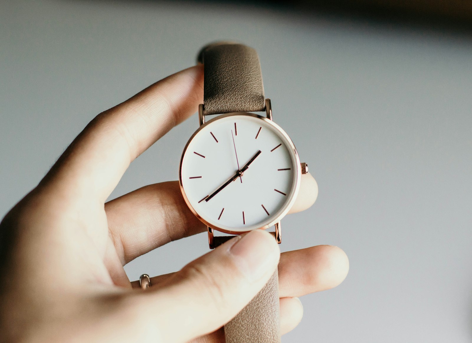 Person holding analog watch