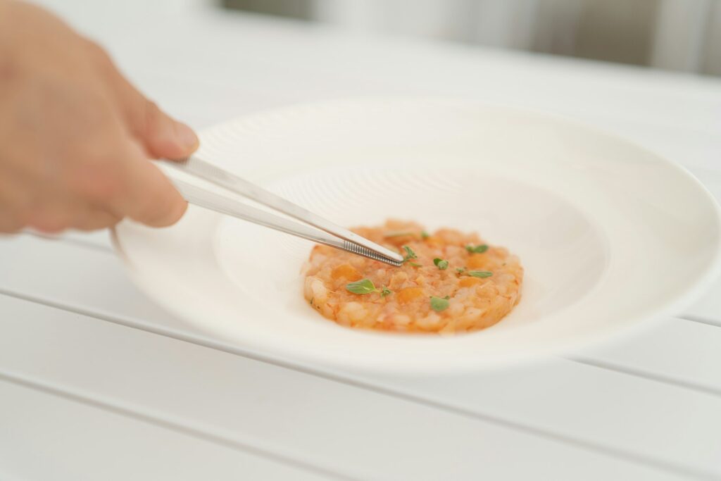 A person holding a fork in a bowl of food