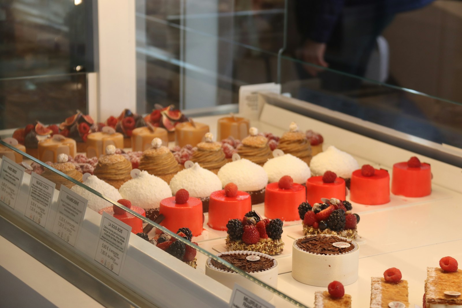 Assortment of colorful and decorative pastries in a display case