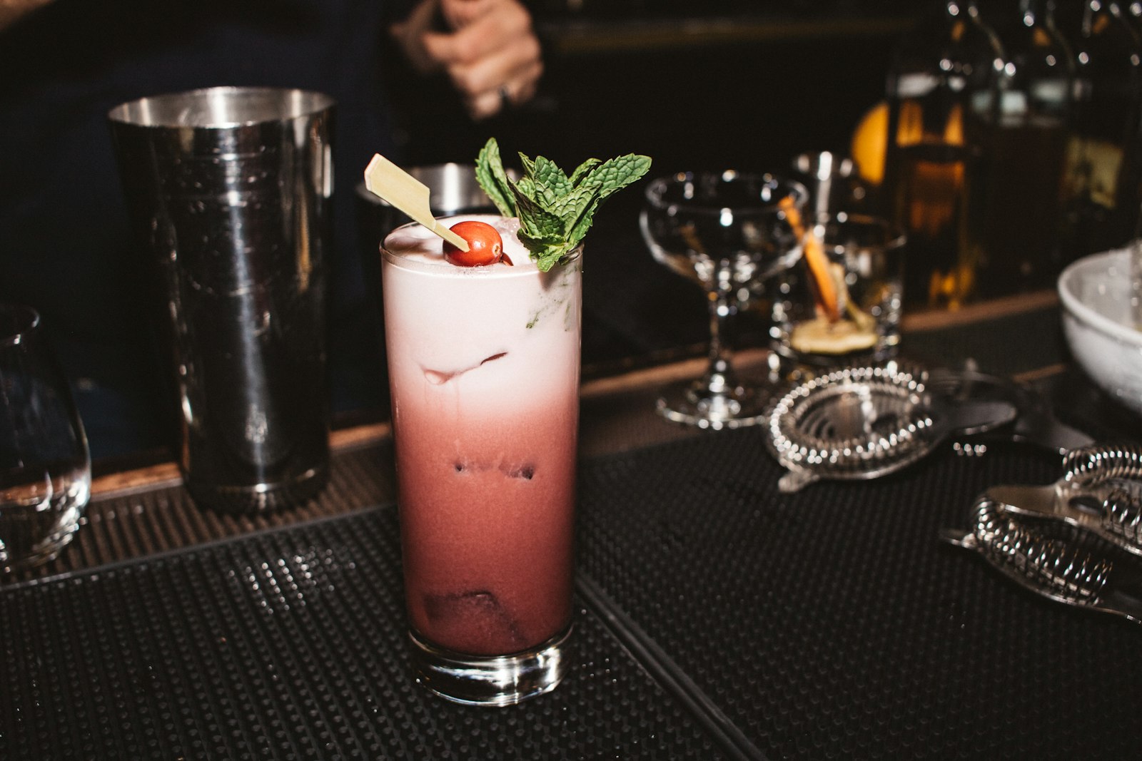 A tall glass filled with a drink sitting on top of a table