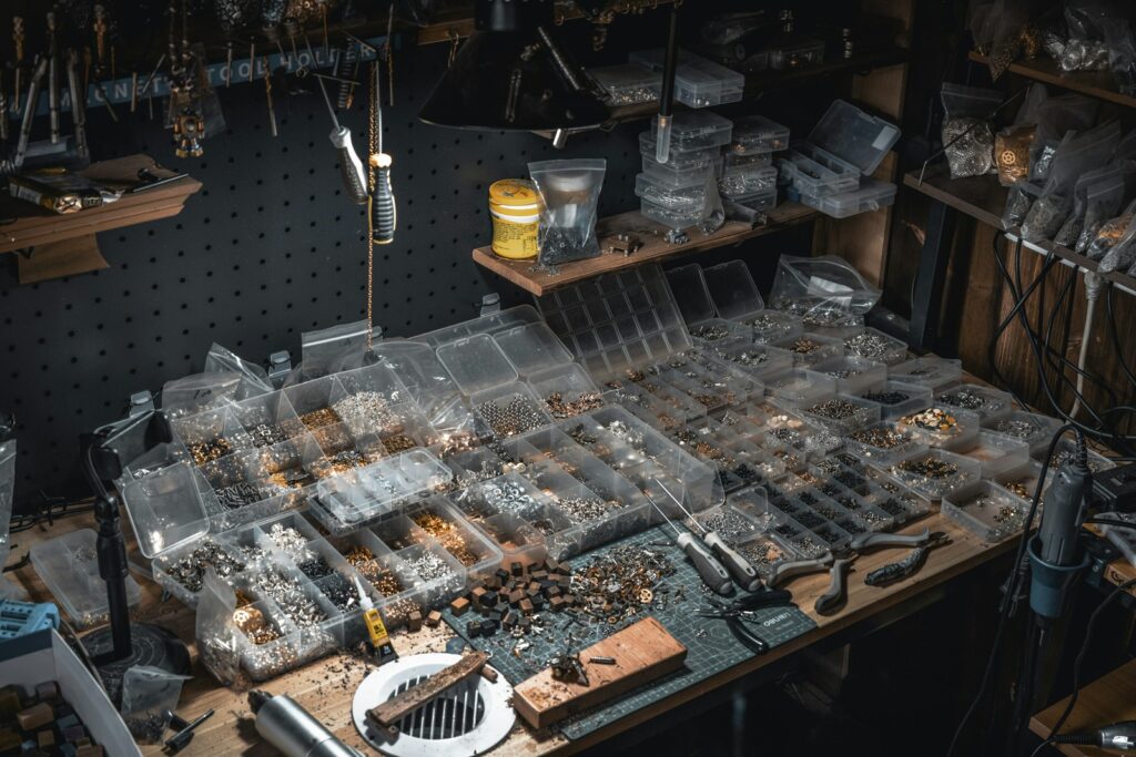 A cluttered workbench filled with various crafting supplies and tools