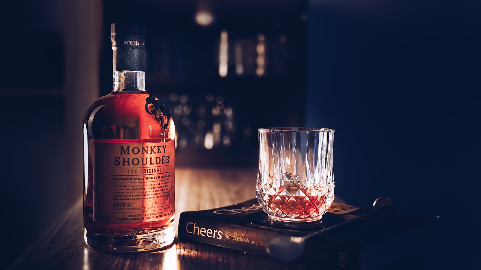 A bottle of whiskey and a glass on a table