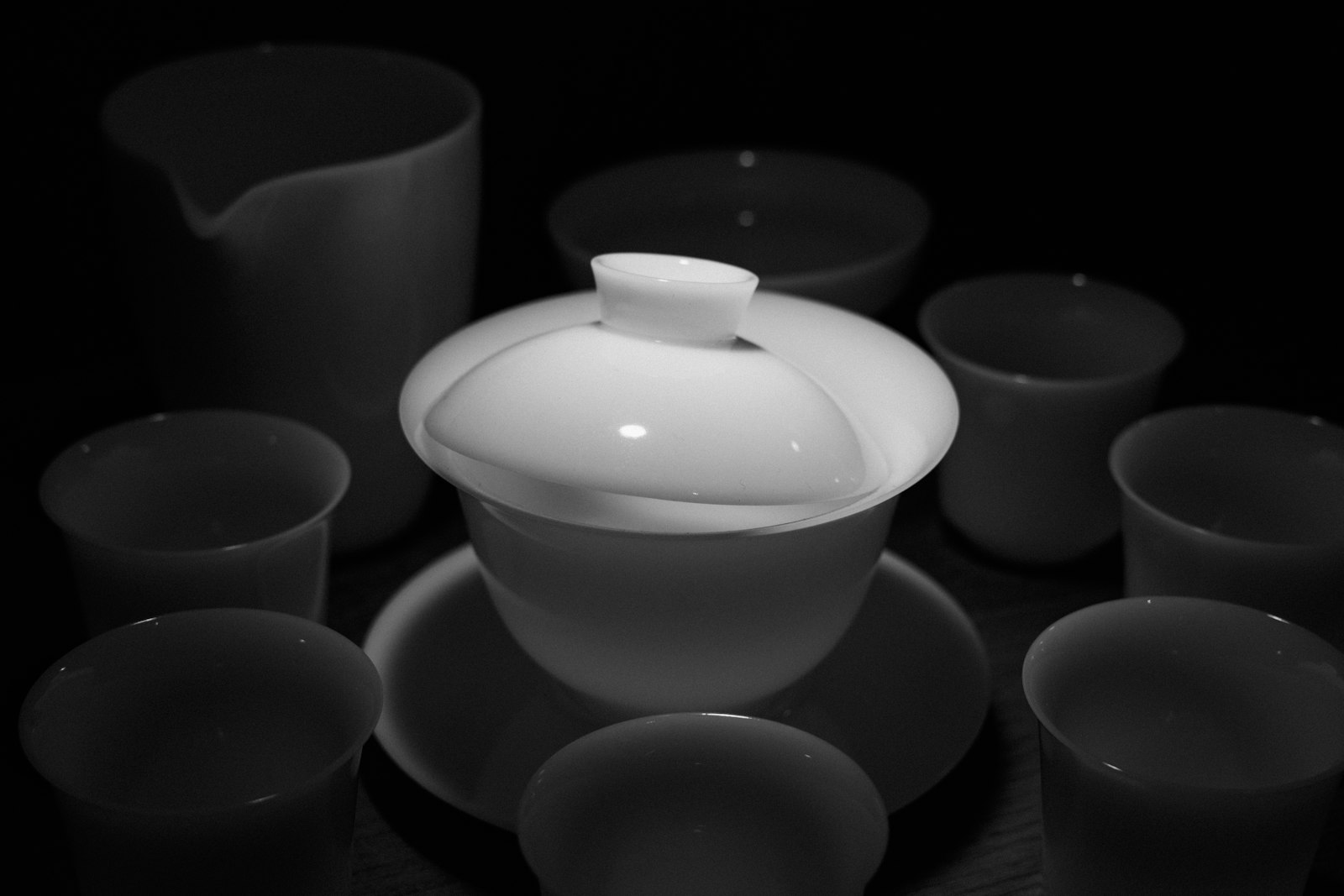 White tea set arranged on dark background