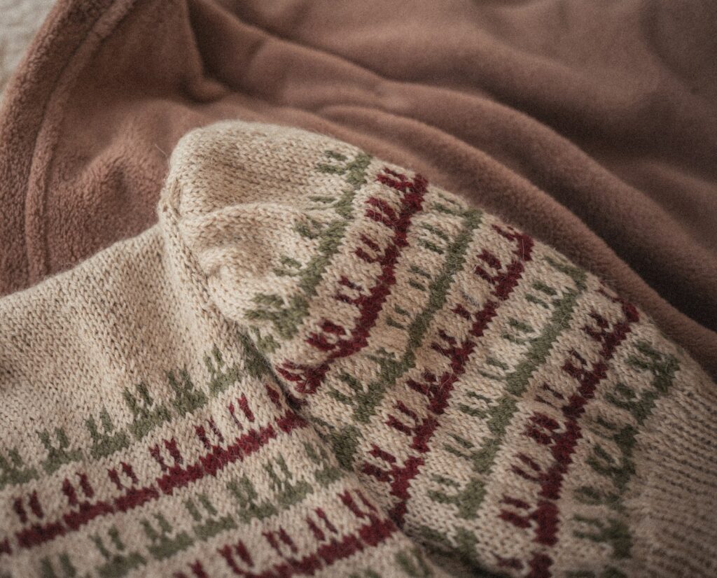 A close up of a blanket on a bed