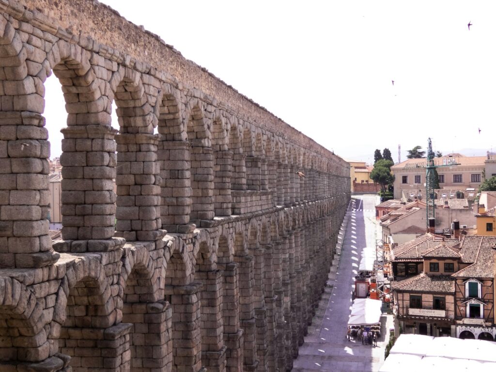Ancient roman aqueduct stretches across a city