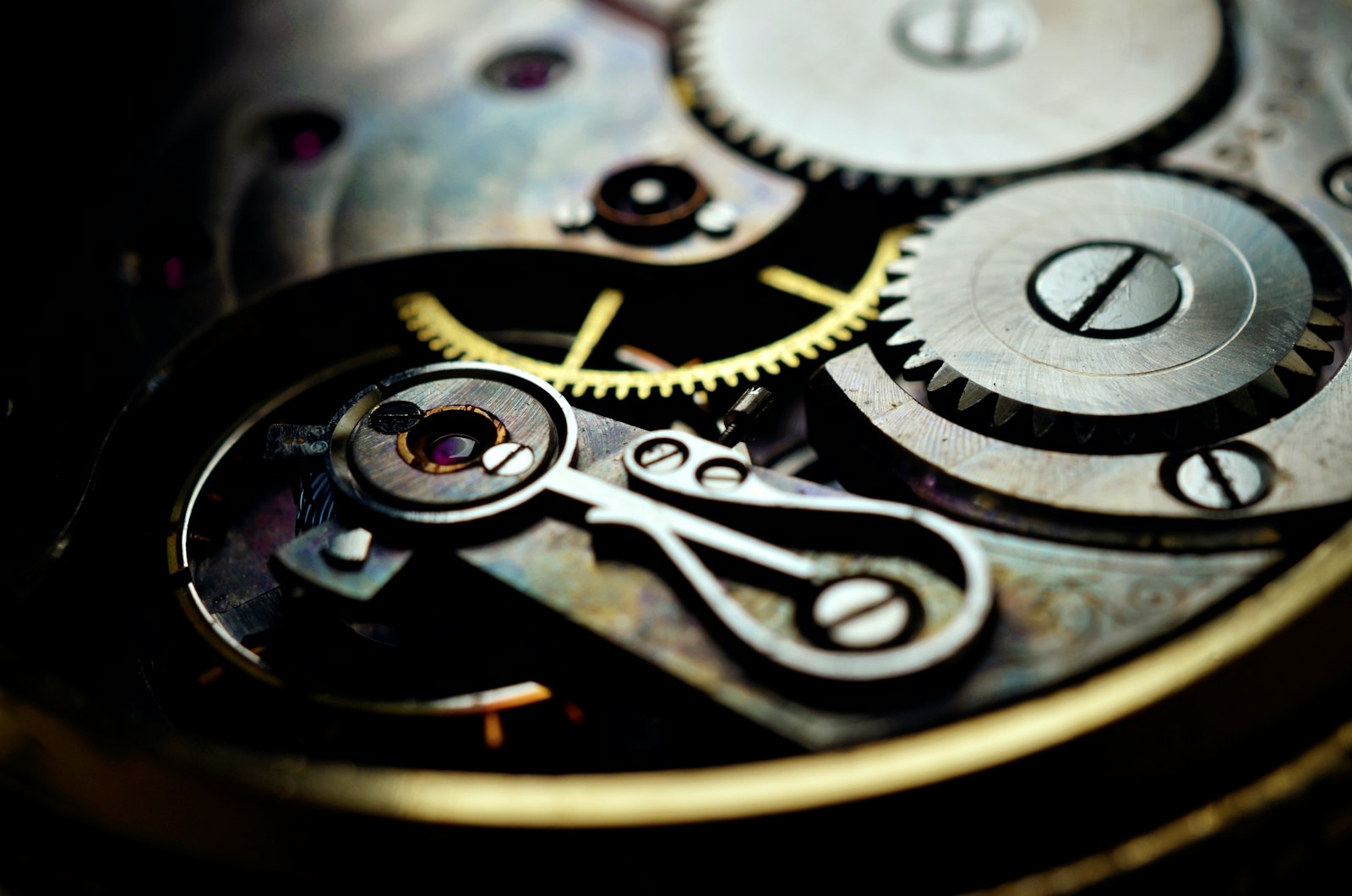 A close up of a watch face showing the gears